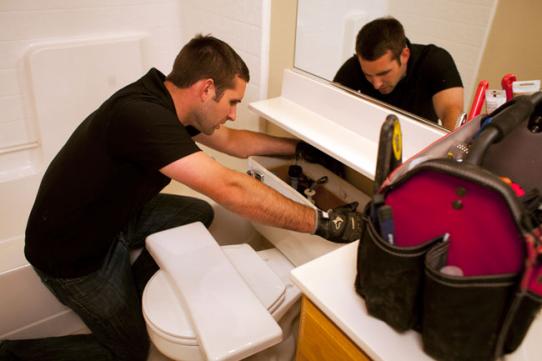 Plumber in Bakersfield repairs a toilet by replacing the float valve