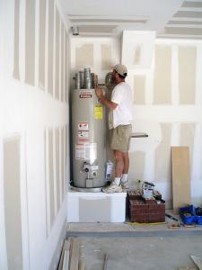 one of our Bakersfield plumbers is fixing a water heater